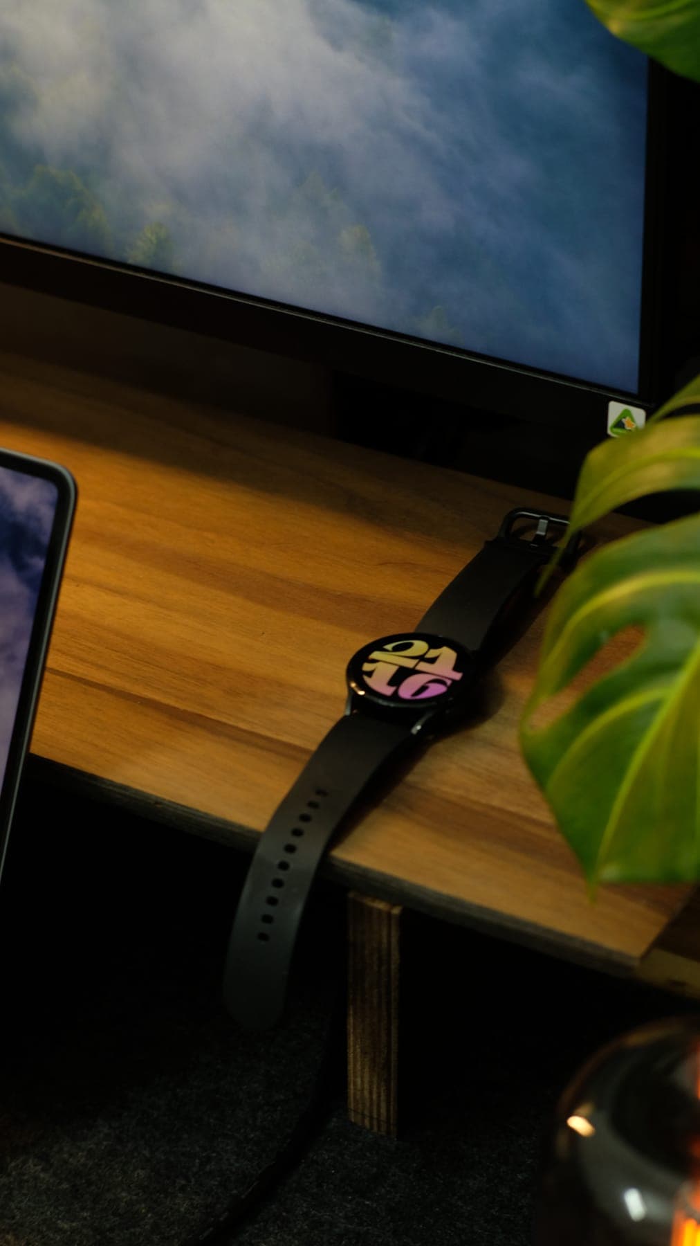 A smartwatch resting on a wooden desk